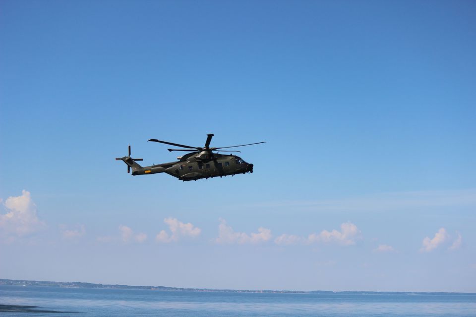 Helicopter flying above sea.