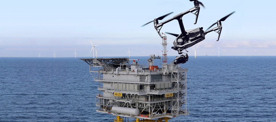 Drone flying by an offshore rig.