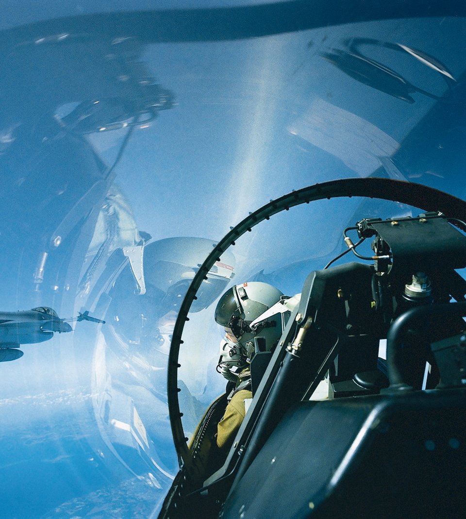 Pilot in F-16 cockpit with 3D-Audio headset.