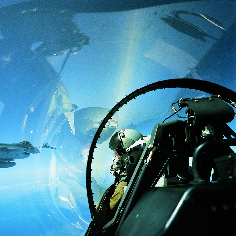 Pilot in F-16 cockpit with 3D-Audio headset.