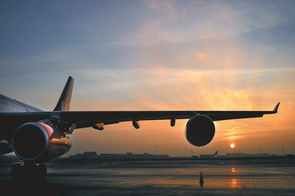 The wing of an aircraft in the Sunrise at Copenhagen Airport.