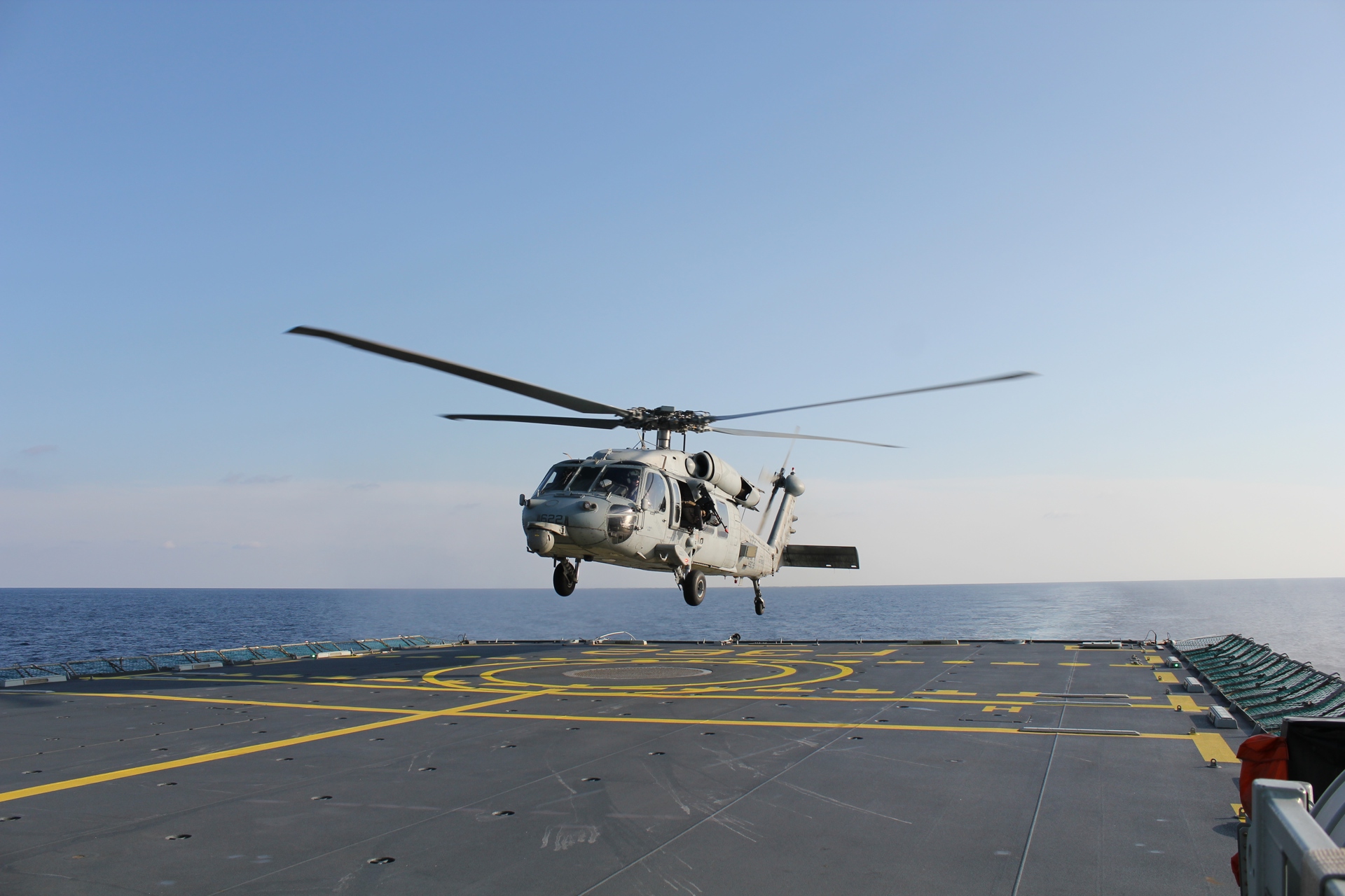 helicopter landing on a navy vessel.