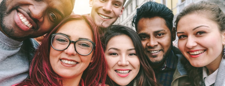 People looking at the camera and smiling.