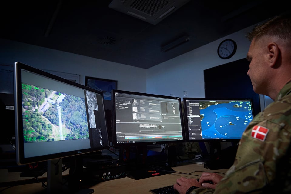 Danish Air Force employee looking at JIMAPS in the command and control room.