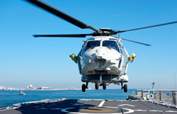 Helicopter landing on navy vessel.